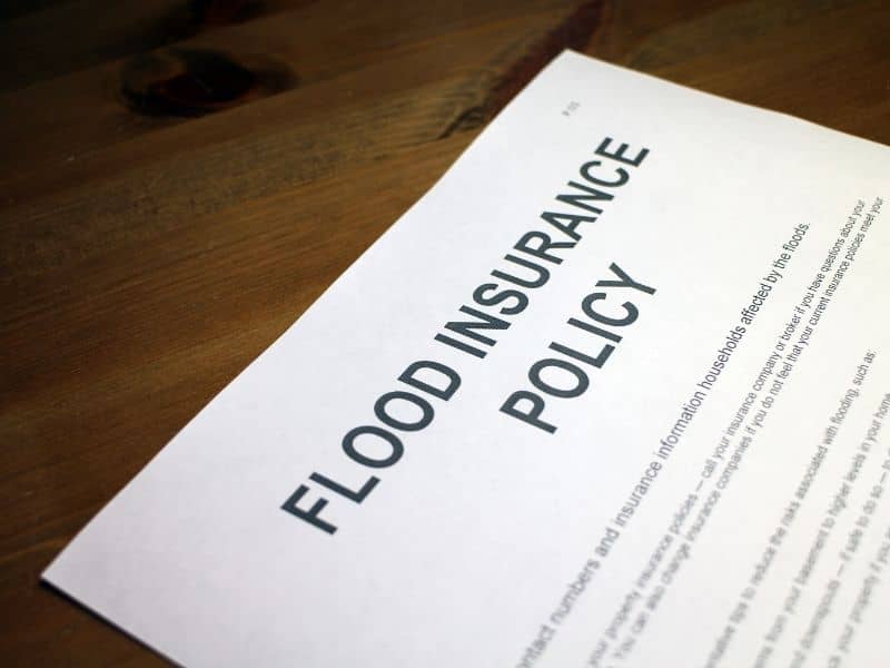 Flood insurance policy paperwork used by homeowners when reviewing elevation certificate information and coverage requirements